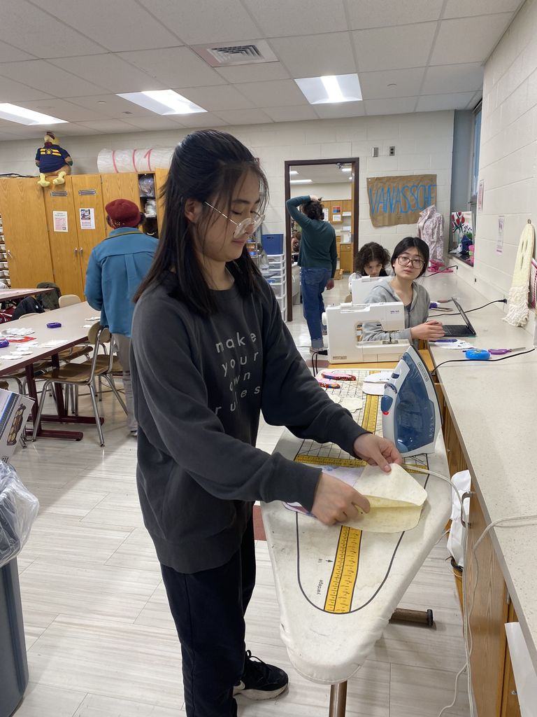 A girl ironing something