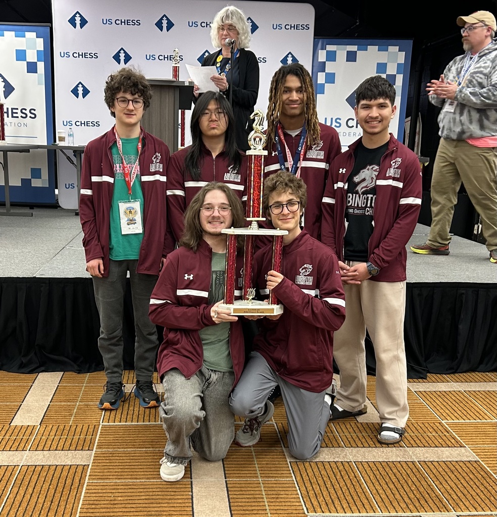 Students holding the chess trophy 