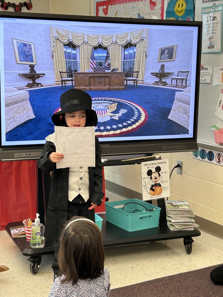 A student presenting their project dressed as a president