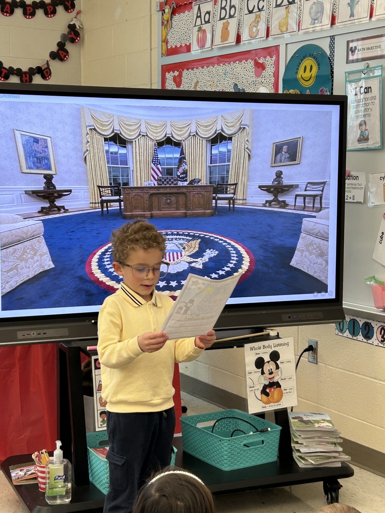 A student presenting their project dressed as a president