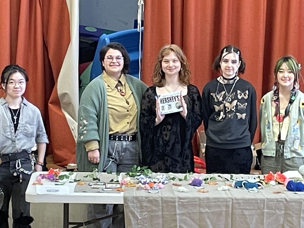 Mckenzy with the vendors smiling at the camera