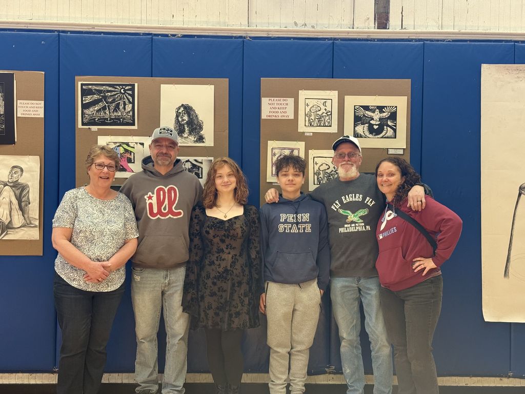 Mckenzy and her family smiling at the camera
