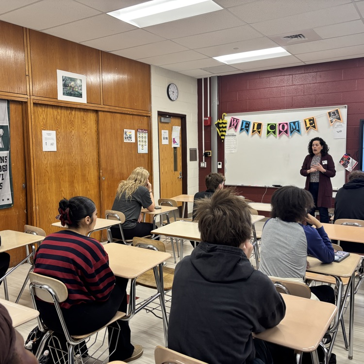 speaker speaks in front of students 