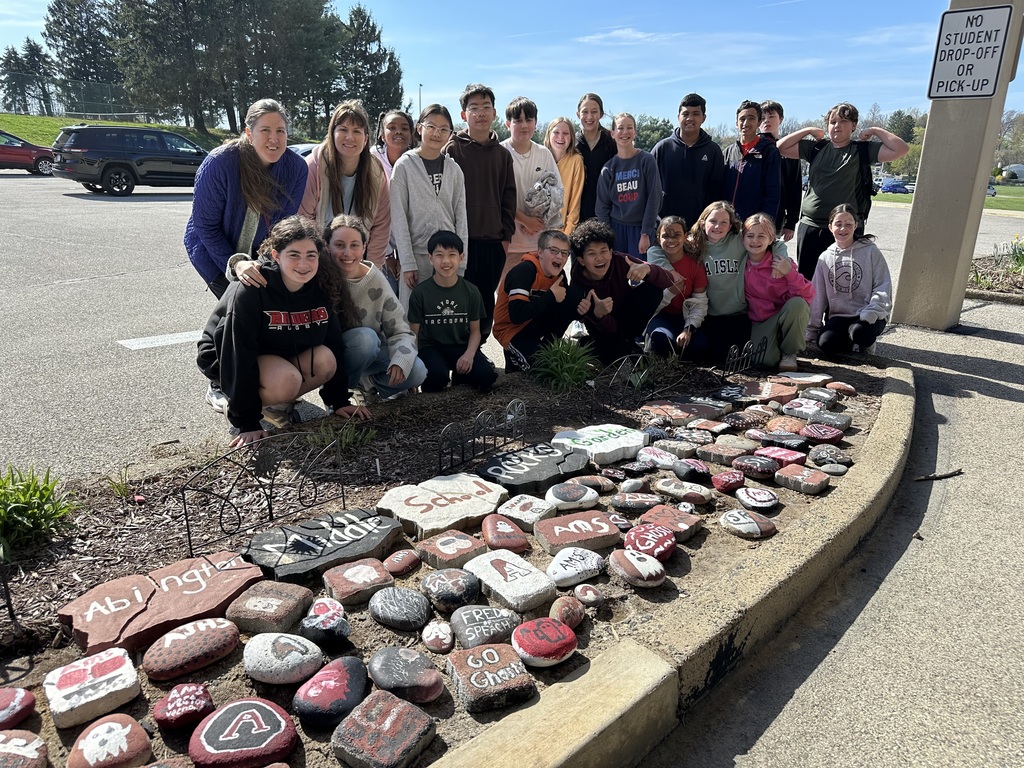 Image of students in the Going Green Club finished giving the school spirit rock garden its spring refresh.