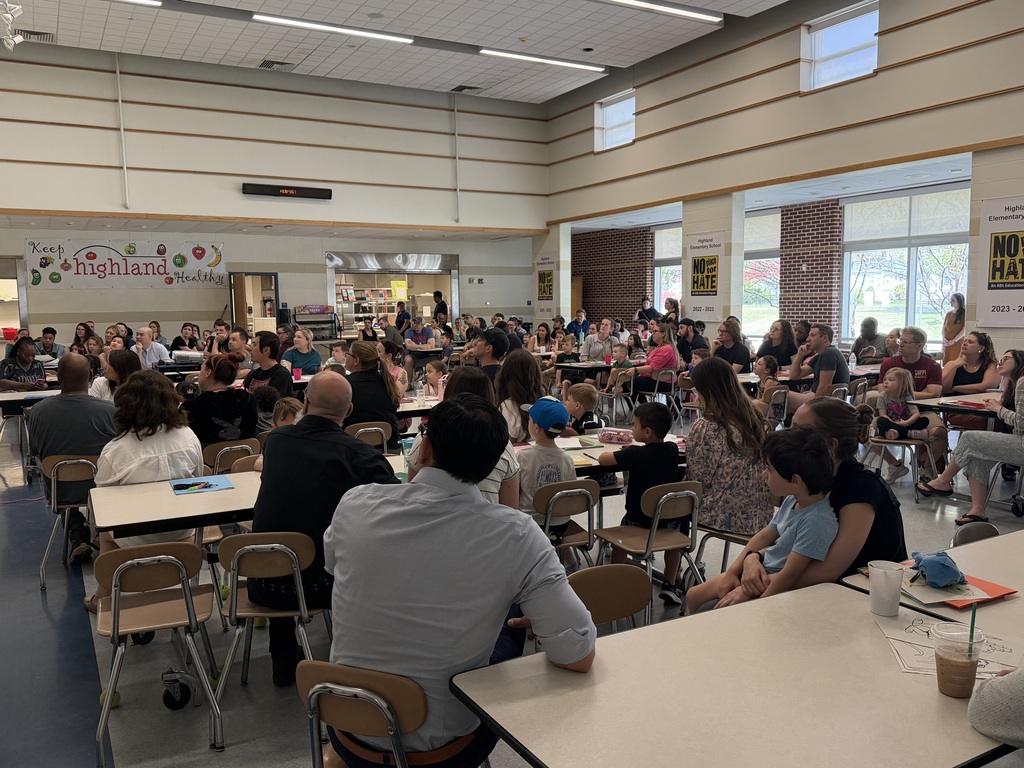 Parents and children at kindergarten orientation in the cafeteria. 