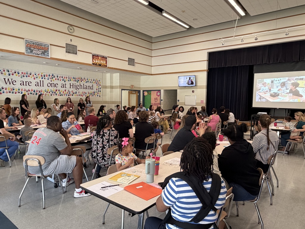 Parents and children at kindergarten orientation in the cafeteria. 