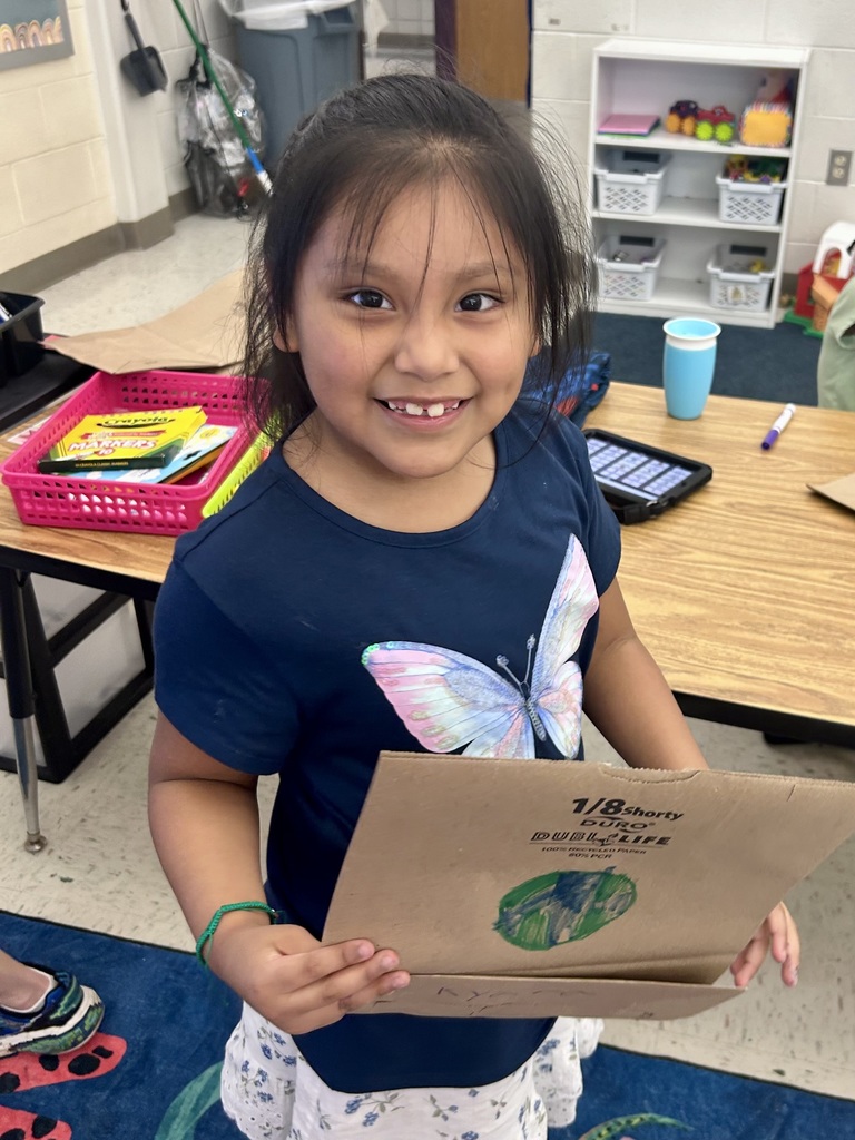 student smiling with an Earth Day bag