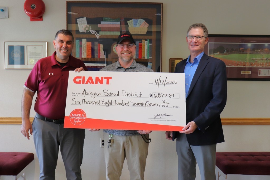 Mr. Tagliaferro and Dr. Rosenthal holding a giant check alongside the GIANT store representative from Roslyn