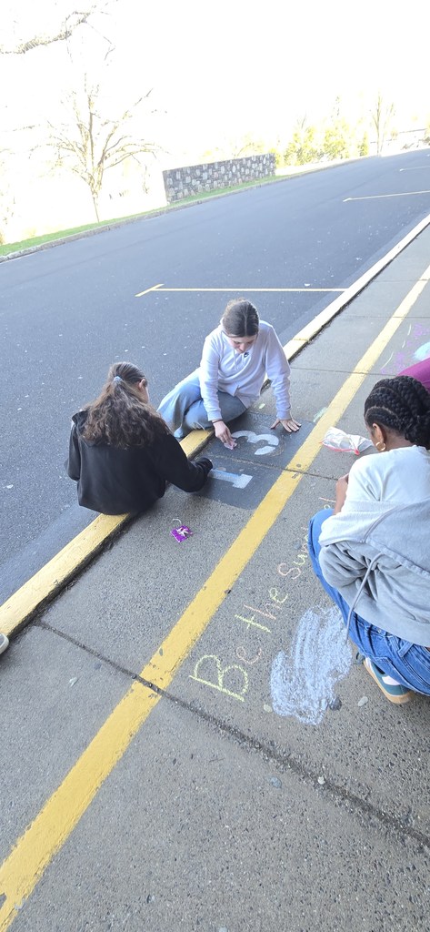 Image of Builders Club members decorating the bus loop.