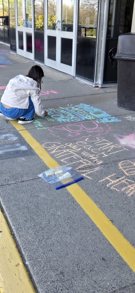 Image of Builders Club members decorating the bus loop.