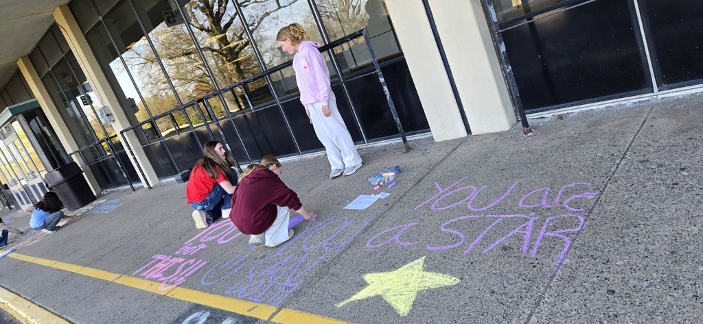 Image of Builders Club members decorating the bus loop.