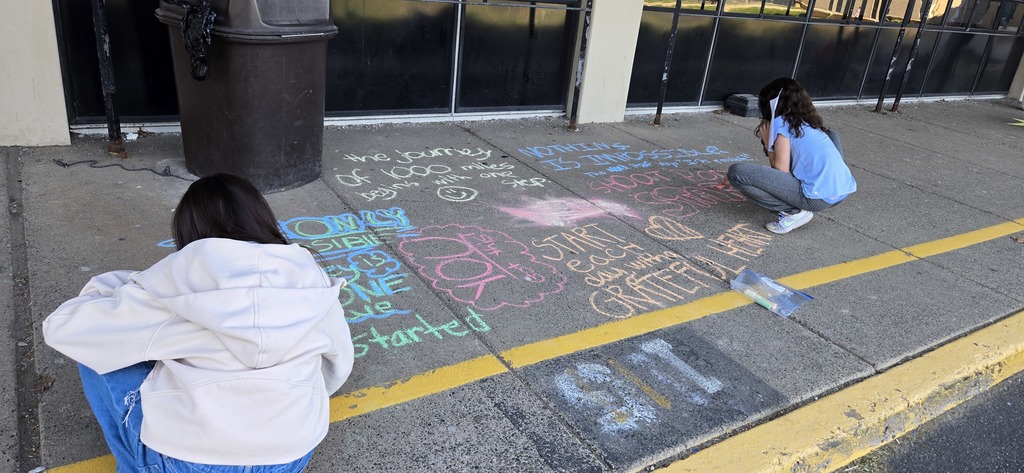 Image of Builders Club members decorating the bus loop.