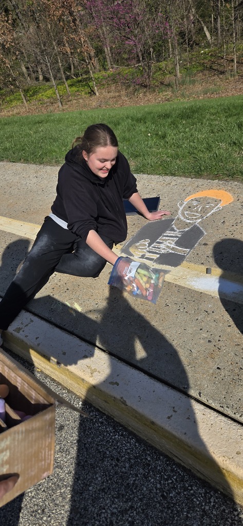 Image of Builders Club members decorating the bus loop.