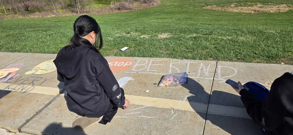 Image of Builders Club members decorating the bus loop.