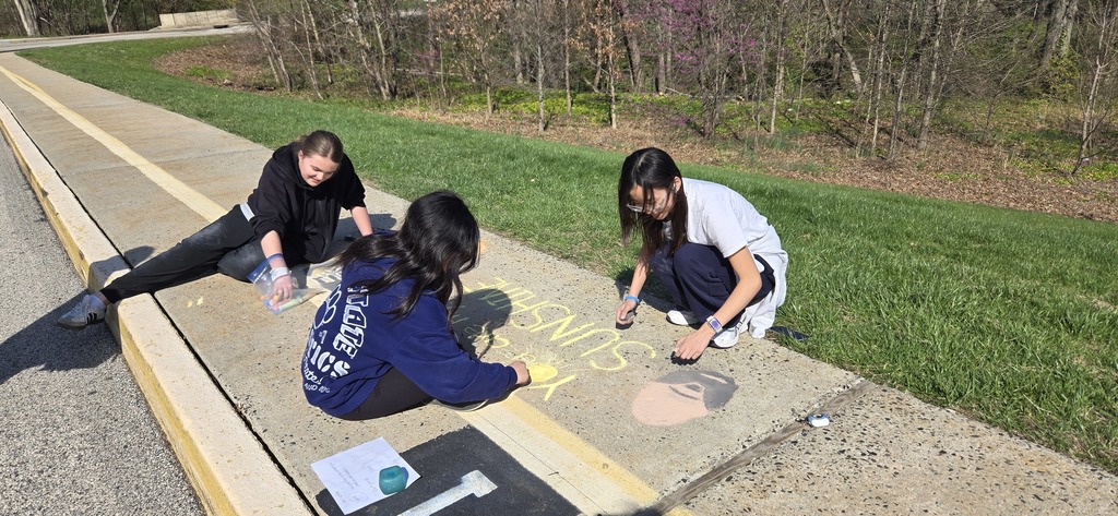 Image of Builders Club members decorating the bus loop.