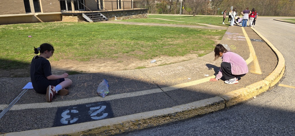 Image of Builders Club members decorating the bus loop.