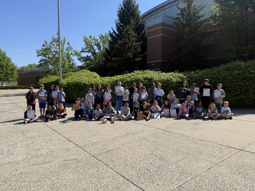 Students smiling for an Earth Day scavenger hunt
