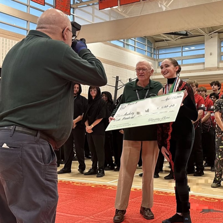 12th grader in the ASHS Scholastic A Colorguard Audrey Pachuta receiving TIA chapters scholarship 