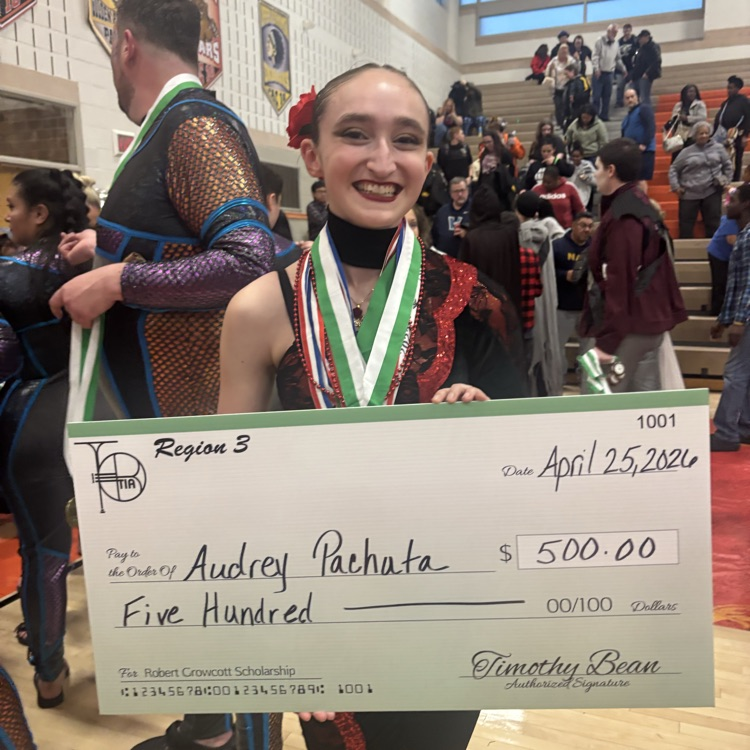 12th grader in the ASHS Scholastic A Colorguard Audrey Pachuta receiving TIA chapters scholarship