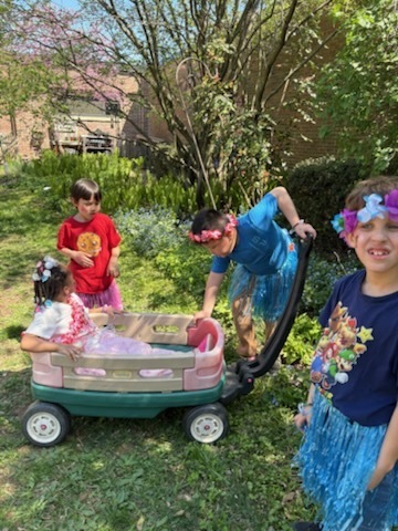 Students get ready for a ride in a wagon at the McKinley Autism Awareness event