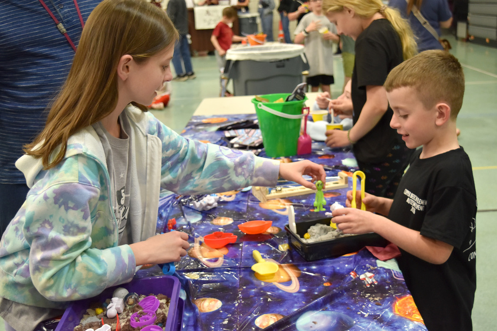 Students dig in the sand for treasures at the Copper Beech Autism Awareness event