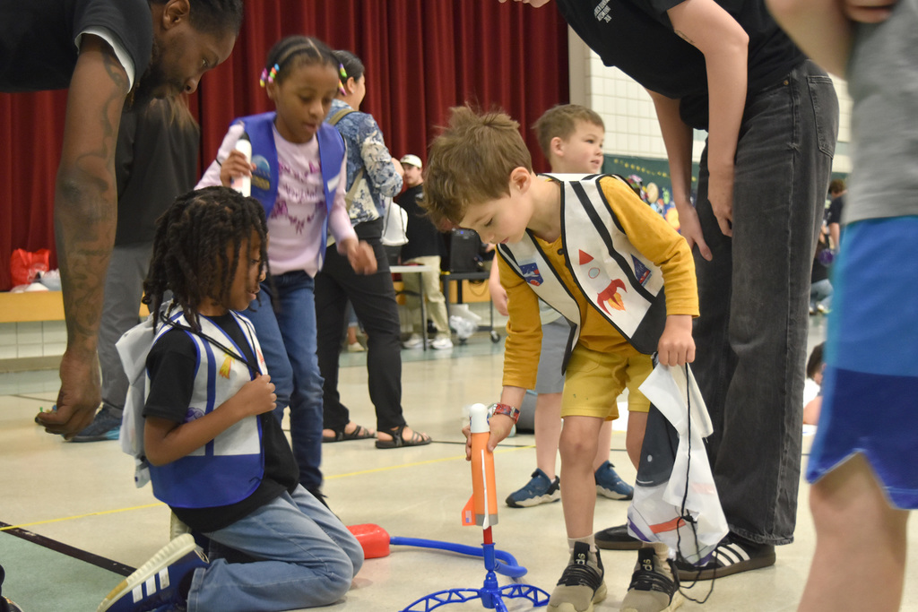 Students set up a self-propelled rocket at the Copper Beech Autism Awareness event