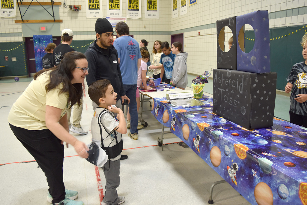 A student aims a ball of  foil at a target at the Copper Beech Autism Awareness event