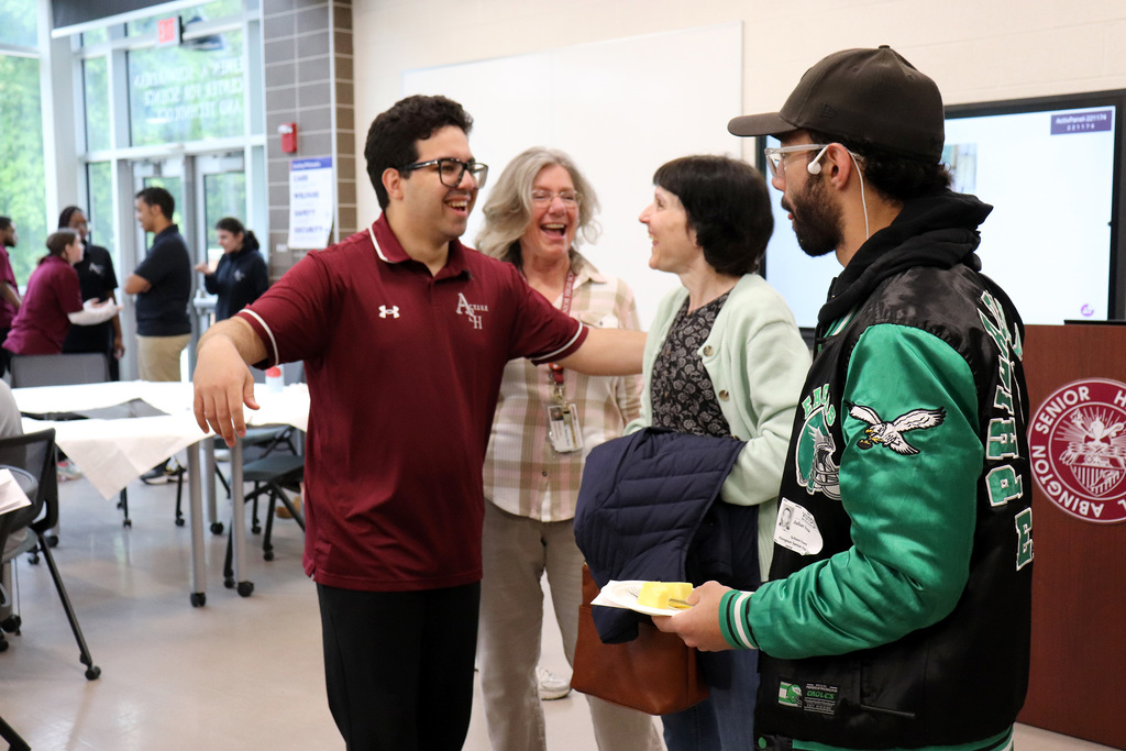 An ACTIVE student laughs with staff and supporting organization members