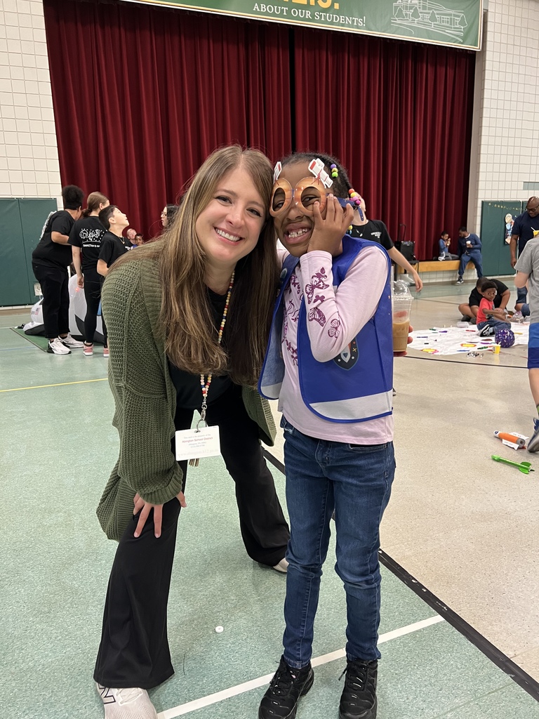 Student smiling with special guests at the Autism Event