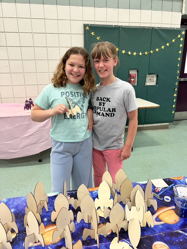 Student smiling with special guests at the Autism Event