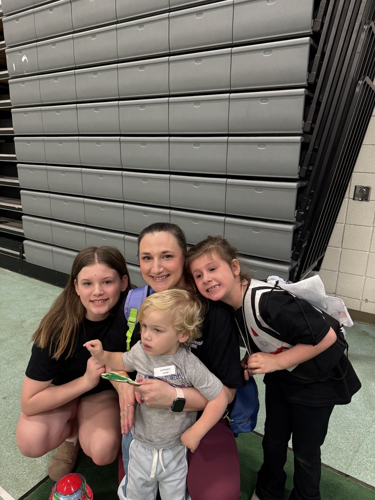 Student smiling with special guests at the Autism Event