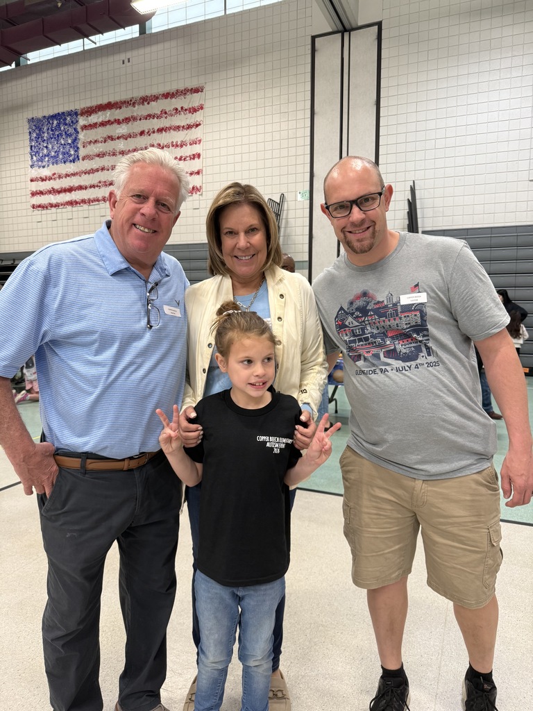 Student smiling with special guests at the Autism Event