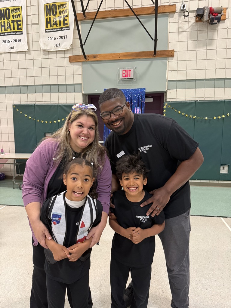Student smiling with special guests at the Autism Event