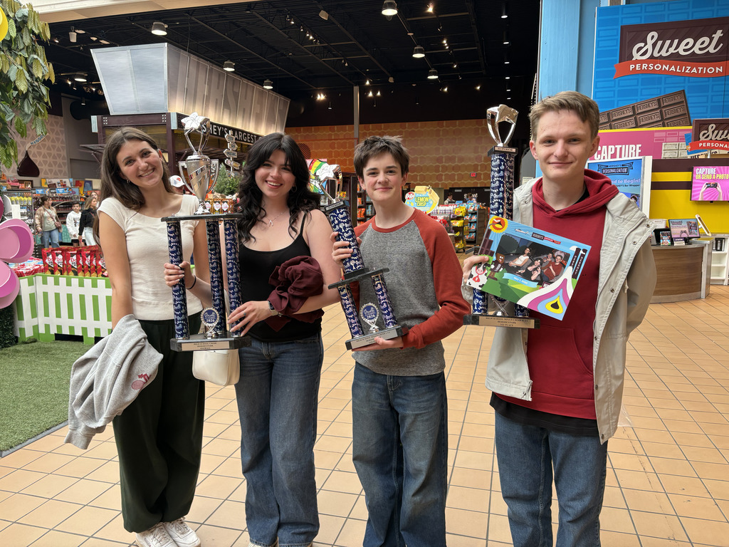 students holding trophies 