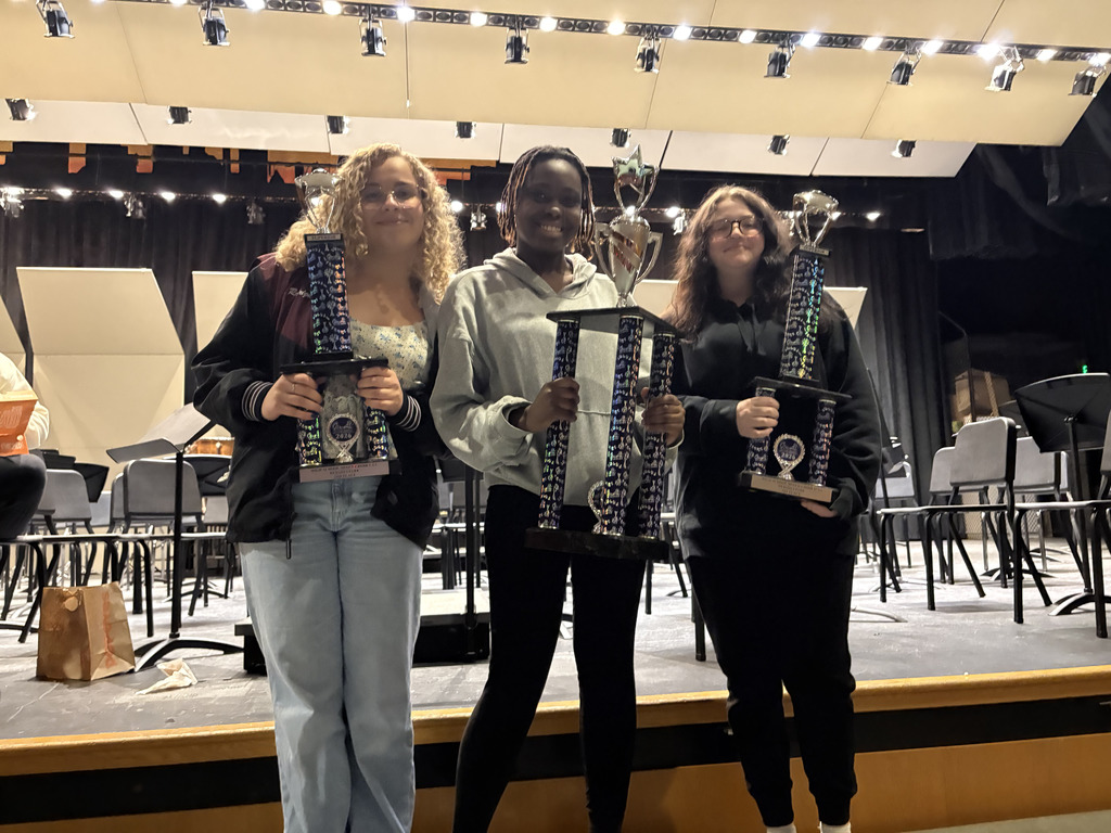 students holding trophies 