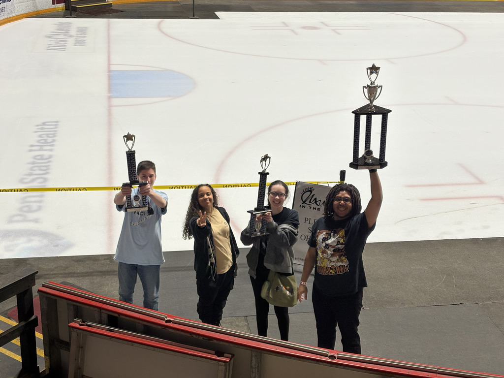 students celebrating with trohpies