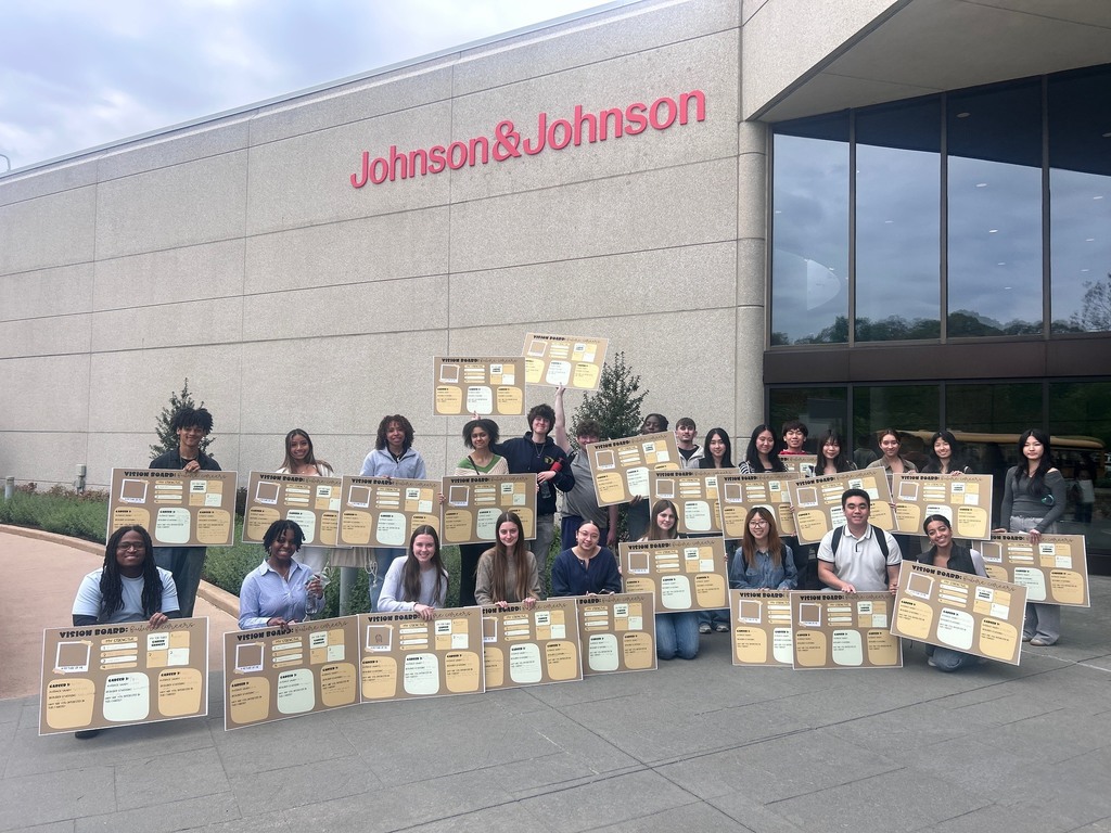 Students with their projects in front of the J&J building