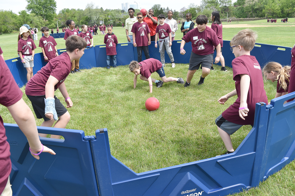 5th graders at CommUNITY Day play Pickleball within blue guard walls