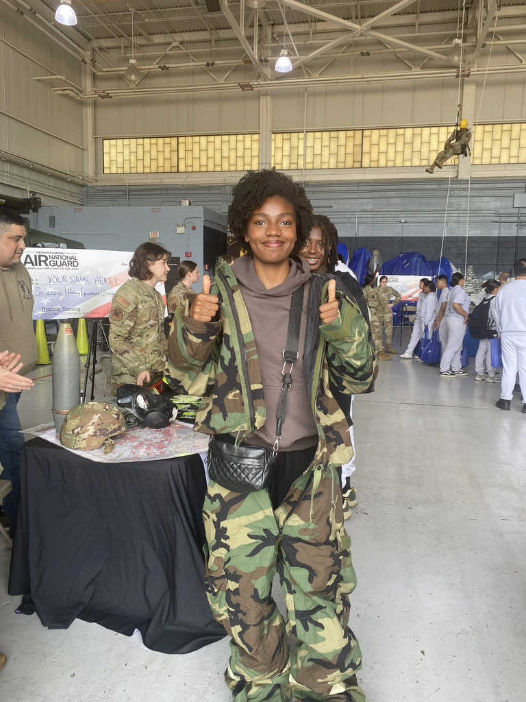 An ASHS student gives the thumbs-up dressed in an Air National Guard uniform
