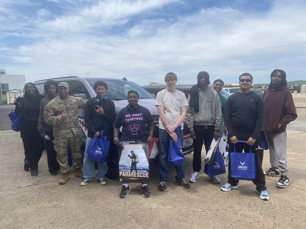 ASHS students pose with a service member at Biddle Air Force Base