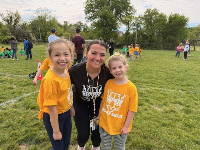 students and staff smiling at field day
