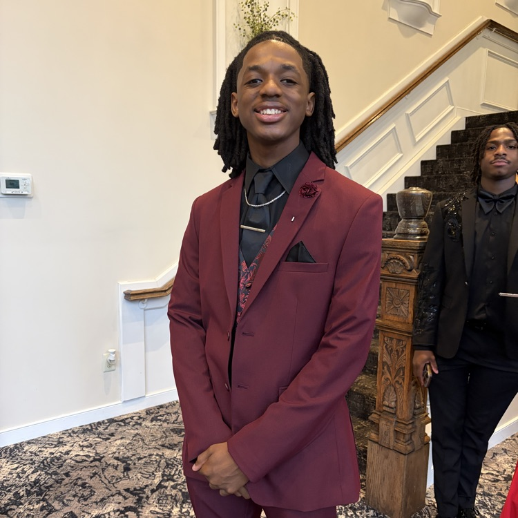 Student dressed in a maroon suit 