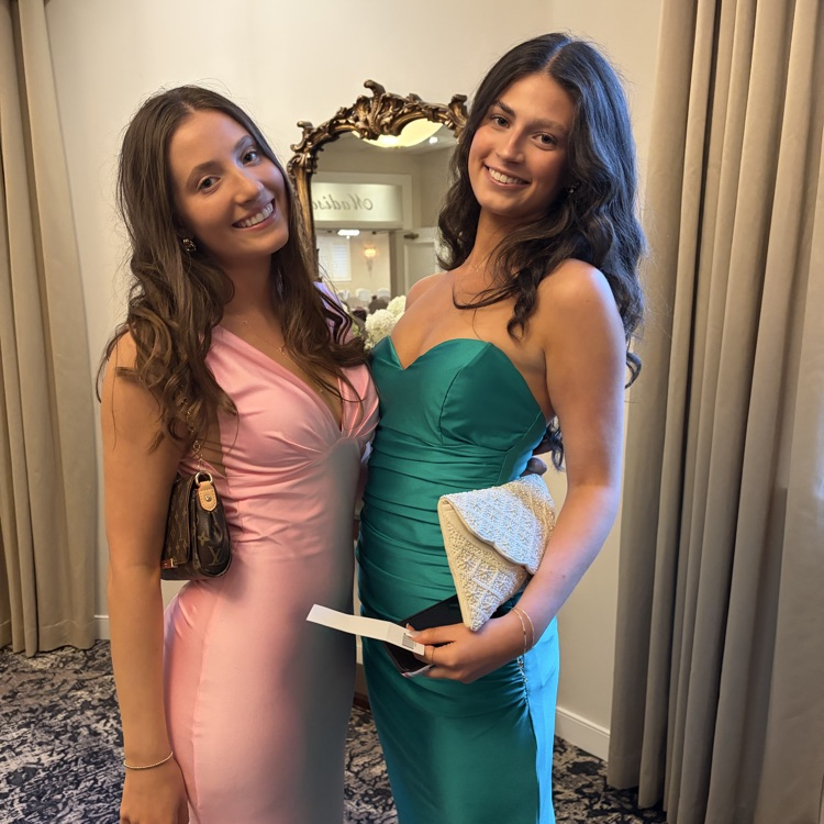 Students at prom in a green dress and a pink dress