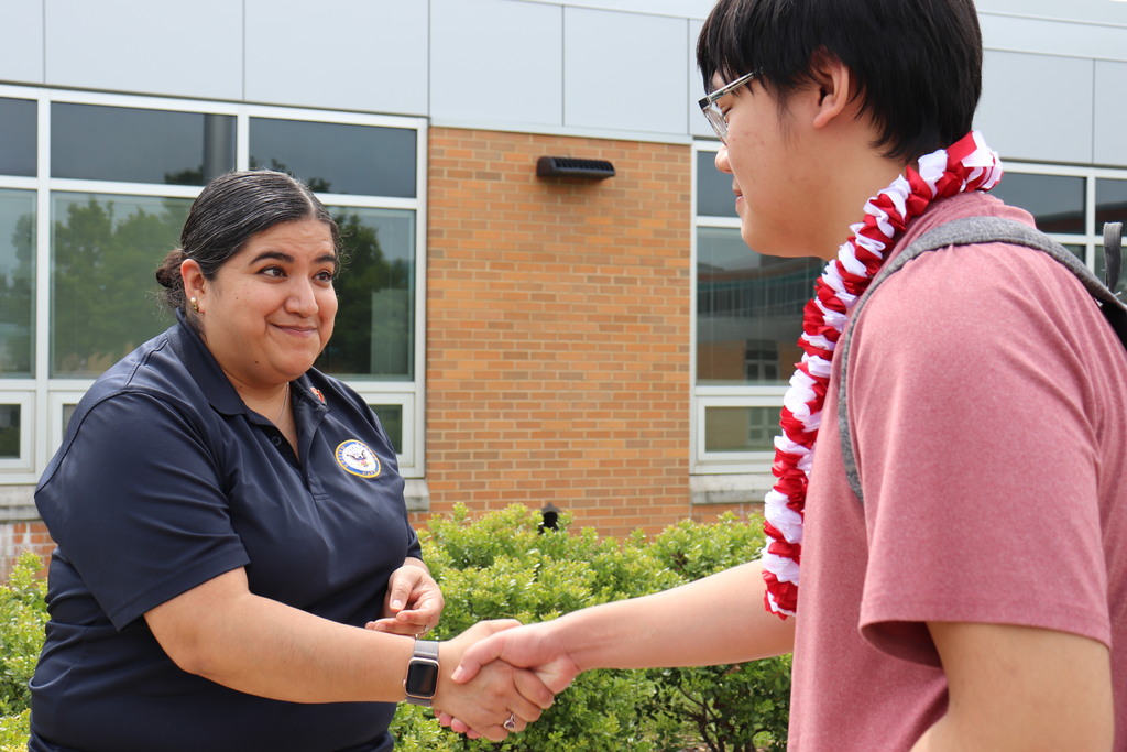 Senior Kevin is recognized by Ms. Vanassche for his service to the Military Club