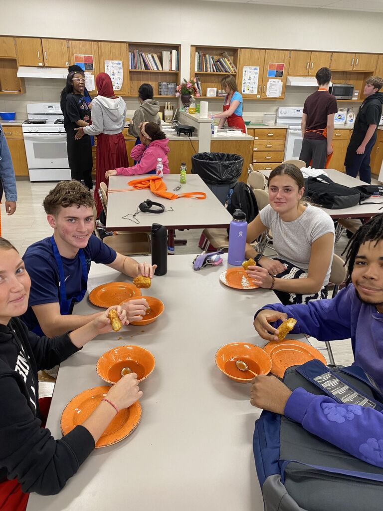 Abington High School students enjoying meal and smiling at camera