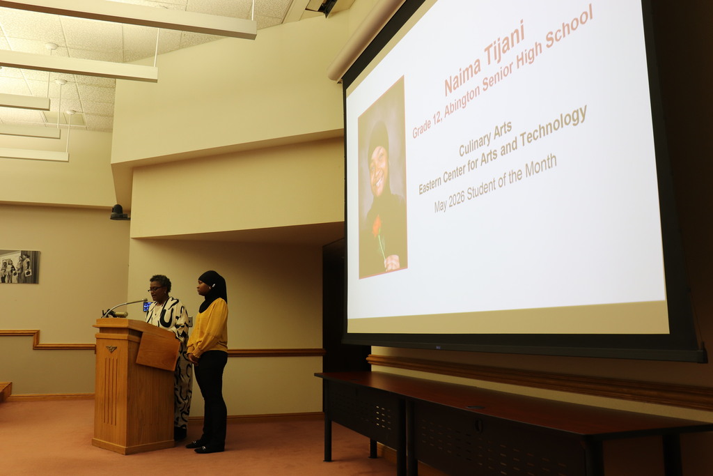 Naima being recognized at the podium by Dr. Wormley