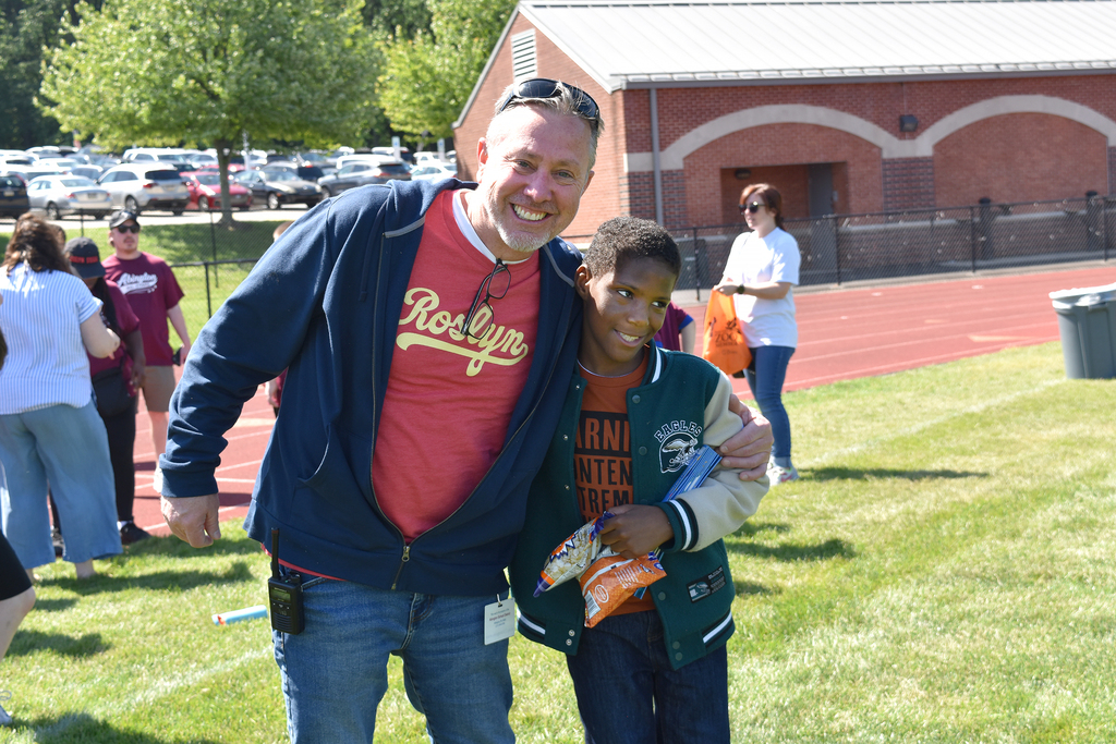 Dr. Osborne poses with a student, smiling