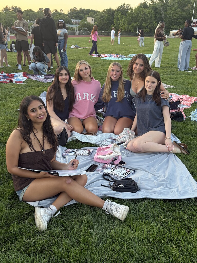 Students sign each other's yearbooks at Senior Sunset
