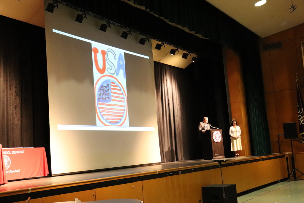 Dr. Fecher and Dr. Mowry welcome attendees with patriotic artwork on display on the screen