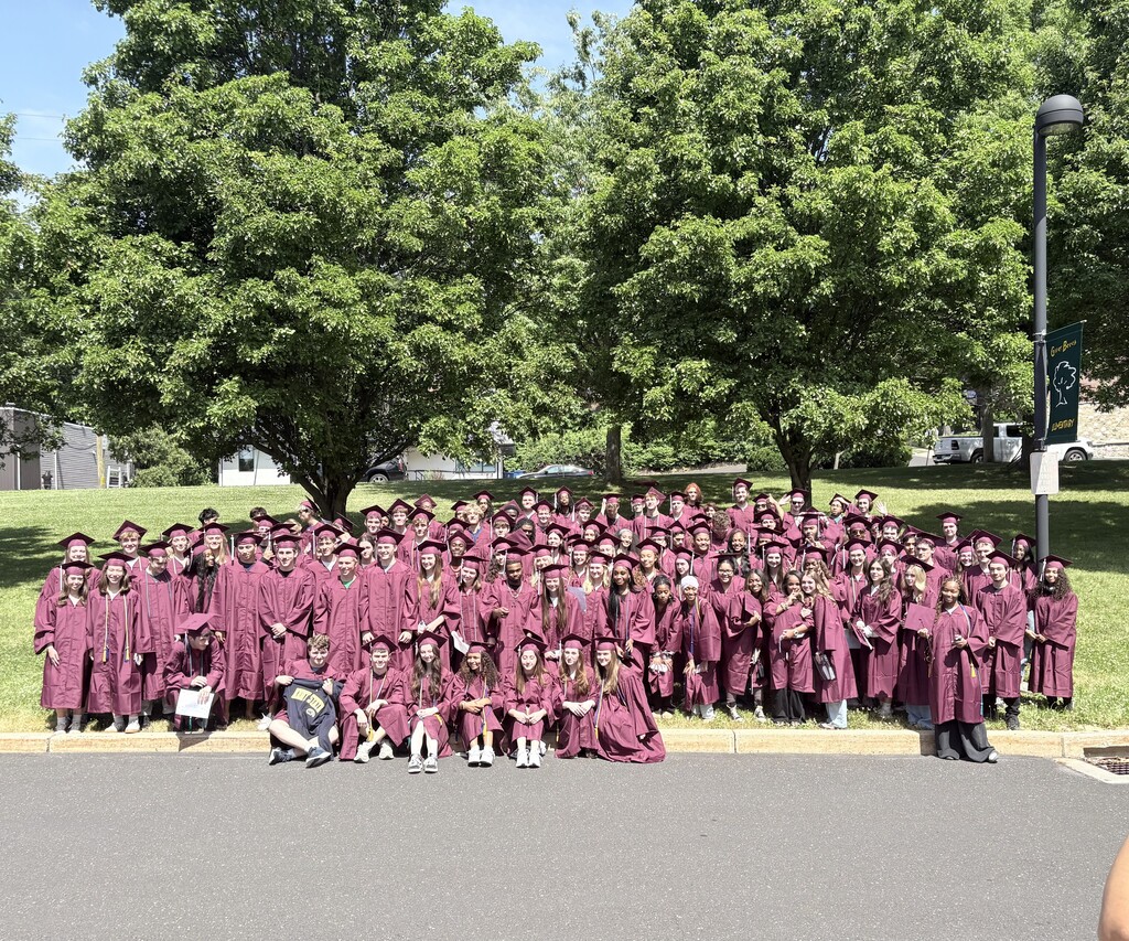 Students at Copper Beech take a group photo in their caps and gowns